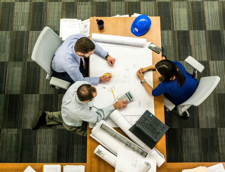 A team of professionals collaborating on planning for Software Managed Services.