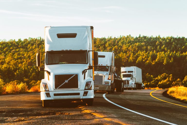 Three fleet trucks monitored by IoT fleet management technology.